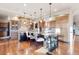 Spacious kitchen with island seating, wood cabinets and a stone backsplash over a cooktop at 5810 Amber Ridge Dr, Castle Pines, CO 80108