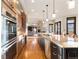 Spacious kitchen features modern stainless-steel appliances, large island, and an open floor plan to living area at 5810 Amber Ridge Dr, Castle Pines, CO 80108