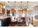 Bright kitchen with island seating, stainless steel appliances, and pendant lighting at 5810 Amber Ridge Dr, Castle Pines, CO 80108