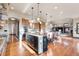 Open kitchen with an expansive center island and a seamless transition to the inviting living space at 5810 Amber Ridge Dr, Castle Pines, CO 80108