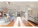 Bright living room with stone fireplace, hardwood floors, and large windows at 5810 Amber Ridge Dr, Castle Pines, CO 80108
