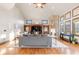 Bright living room with a stone fireplace, custom built-ins, and hardwood floors at 5810 Amber Ridge Dr, Castle Pines, CO 80108