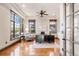 Well-lit home office with hardwood floors, tray ceilings, large windows, a ceiling fan, and classic furnishings at 5810 Amber Ridge Dr, Castle Pines, CO 80108