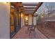 Cozy patio featuring a small table and chairs, framed by an open pergola at 5810 Amber Ridge Dr, Castle Pines, CO 80108