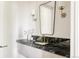 Stylish bathroom features a sleek marble countertop, modern fixtures, and elegant lighting at 8937 Little Raven Trl, Niwot, CO 80503