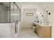 Bathroom featuring a glass enclosed shower and double vanity with marble countertops at 8937 Little Raven Trl, Niwot, CO 80503