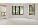 Bright bedroom with large windows and a door leading to an outdoor patio at 8937 Little Raven Trl, Niwot, CO 80503