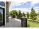 Spacious outdoor deck with stone posts, iron railings, and serene views of the lush landscape at 8937 Little Raven Trl, Niwot, CO 80503