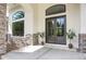 A close up of the front door with stone accents, and a set of matching potted plants at 8937 Little Raven Trl, Niwot, CO 80503