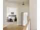Hallway view into a bedroom featuring a gray headboard and neutral tones and a modern decorative mirror at 8937 Little Raven Trl, Niwot, CO 80503