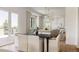 Open-concept kitchen features an island, bar seating, and a bright living area at 8937 Little Raven Trl, Niwot, CO 80503