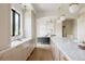 Bright kitchen featuring marble countertops, gold hardware, and an open layout flowing into the living area at 8937 Little Raven Trl, Niwot, CO 80503