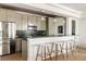 Charming kitchen features stainless steel appliances, bar seating, and modern pendant lighting at 8937 Little Raven Trl, Niwot, CO 80503