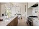 Modern kitchen boasting stainless steel appliances, marble countertops, and gold fixtures for an upscale feel at 8937 Little Raven Trl, Niwot, CO 80503