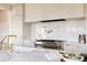 Gourmet kitchen with marble countertops, stainless steel stove, and stylish fixtures at 8937 Little Raven Trl, Niwot, CO 80503