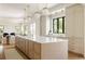 Bright kitchen features a large island with marble countertops and modern globe pendant lighting at 8937 Little Raven Trl, Niwot, CO 80503