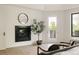 Bright living room with a modern fireplace, round mirror, and access to the balcony at 8937 Little Raven Trl, Niwot, CO 80503