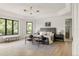 Spacious main bedroom with a tray ceiling, large windows, and designer furnishings at 8937 Little Raven Trl, Niwot, CO 80503