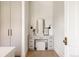 Stylish vanity area with a neutral color palette, decorative mirror, and ample storage at 8937 Little Raven Trl, Niwot, CO 80503