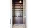 Modern wine cellar with wine racks, dark cabinets, and stone tile flooring at 8937 Little Raven Trl, Niwot, CO 80503