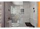 Contemporary bathroom showcasing a sleek glass shower with a built-in seat and stone-accented walls at 11409 Jay St, Westminster, CO 80020