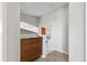 Hallway features modern wood cabinet with drawers and a glimpse of staircase beyond at 11409 Jay St, Westminster, CO 80020