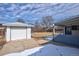 Backyard view features detached garage, ample parking, and a partially covered back porch at 555 W Peakview Ave, Littleton, CO 80120