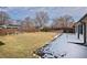 Large backyard with grass, a wooden fence, and some snow on the ground at 555 W Peakview Ave, Littleton, CO 80120