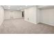 Wide open basement with neutral carpet and light walls, with access to stairs and other rooms at 555 W Peakview Ave, Littleton, CO 80120