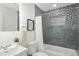 This bathroom features tile backsplash, shower with curtain, a modern mirror, and a sink at 555 W Peakview Ave, Littleton, CO 80120