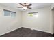 This bedroom features hardwood floors, neutral walls, a ceiling fan, and two windows with blinds at 555 W Peakview Ave, Littleton, CO 80120