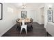 Cozy dining area showcasing a hardwood floors, contemporary decor, and bathed in the sunlight from adjacent window at 555 W Peakview Ave, Littleton, CO 80120