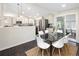 A dining room with a glass table, six chairs, and a view into the kitchen at 555 W Peakview Ave, Littleton, CO 80120