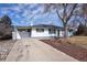 Charming home exterior with a carport, well-manicured landscaping, and a welcoming entrance at 555 W Peakview Ave, Littleton, CO 80120