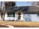 Charming single-story home featuring a modern front door, updated facade, and well-maintained lawn on a sunny day at 555 W Peakview Ave, Littleton, CO 80120