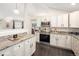 Well-appointed kitchen featuring granite countertops, stainless steel appliances, and sleek white cabinetry in a bright space at 555 W Peakview Ave, Littleton, CO 80120