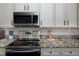 A close up on the kitchen with stainless appliances and granite countertops at 555 W Peakview Ave, Littleton, CO 80120