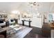 Bright and airy living room showcasing vaulted ceilings, modern decor, and seamless flow to the kitchen and dining area at 555 W Peakview Ave, Littleton, CO 80120