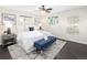 A modern bedroom with a ceiling fan, bench and two windows at 555 W Peakview Ave, Littleton, CO 80120