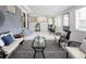 Bright sunroom with brick accent wall, neutral paint, lots of natural light, and casual seating at 555 W Peakview Ave, Littleton, CO 80120