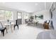 Bright sunroom with neutral paint, lots of natural light, and casual seating with table at 555 W Peakview Ave, Littleton, CO 80120