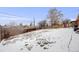 Wide backyard space with snow-covered ground and fencing around the property at 8331 Mason Cir, Westminster, CO 80031