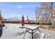 Backyard with a deck, a table and snow-covered ground at 8331 Mason Cir, Westminster, CO 80031