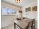 Dining area with a window view, an eye-catching light fixture, and stylish artwork at 8331 Mason Cir, Westminster, CO 80031