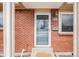 Close-up of the brick front exterior with the front door at 8331 Mason Cir, Westminster, CO 80031