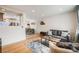 Open-concept living room featuring a comfortable sofa and seamless transition to the dining area at 8331 Mason Cir, Westminster, CO 80031