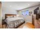 Bright main bedroom features hardwood floors, nice windows, and a large dresser at 8331 Mason Cir, Westminster, CO 80031