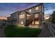 A multi-level deck and lush lawn create an inviting outdoor living space in this beautifully maintained backyard at 2668 Scoter Ln, Castle Rock, CO 80104
