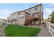 Backyard with home exterior featuring a deck with stairs, green grass, and gravel at 2668 Scoter Ln, Castle Rock, CO 80104