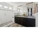 Bathroom featuring a glass-enclosed shower, double vanity, granite countertop, and modern fixtures at 2668 Scoter Ln, Castle Rock, CO 80104